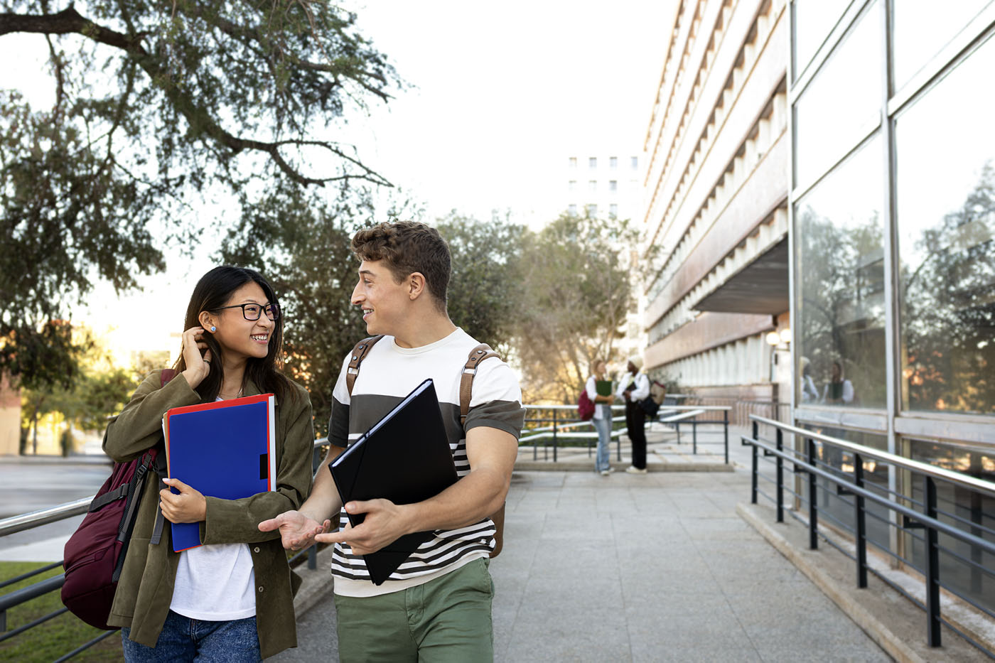 Multiracial college student friends walking together on campus. Copy space.Gen z and higher education concept.